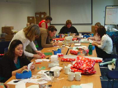 Volunteers wrap gifts donated as part of last year