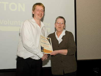 Pat Notton receives her award from Kevin Quinn of 