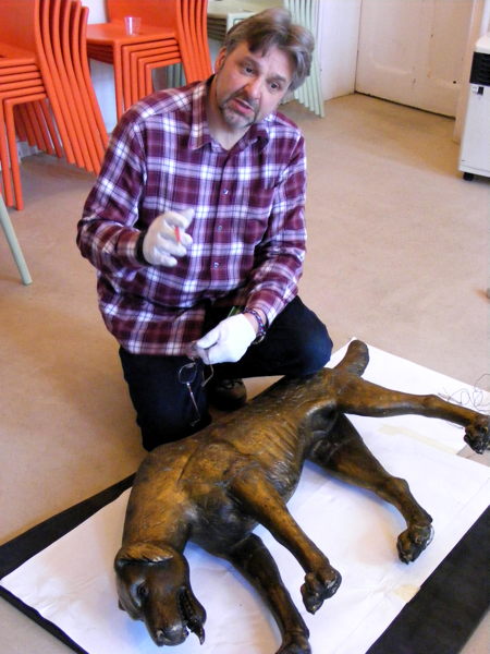 Woodcarver measures Dickensian wooden dog for replica