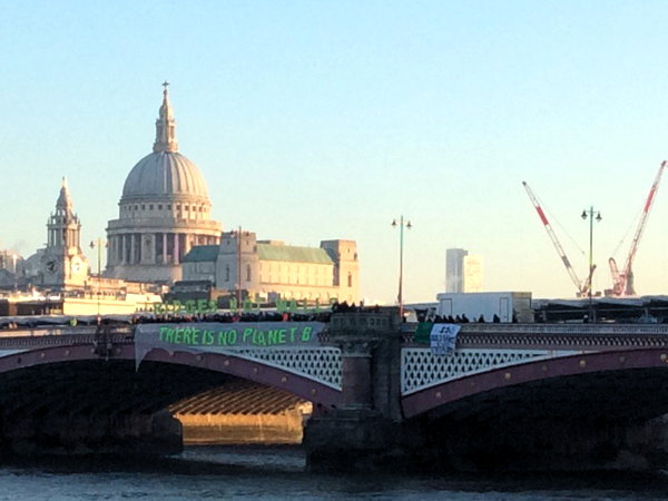 Trump inauguration: campaigners unfurl banners on Thames bridges