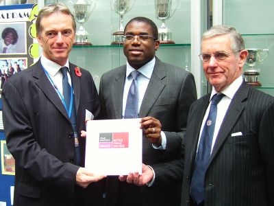 David Lammy (centre) presents the award to princip