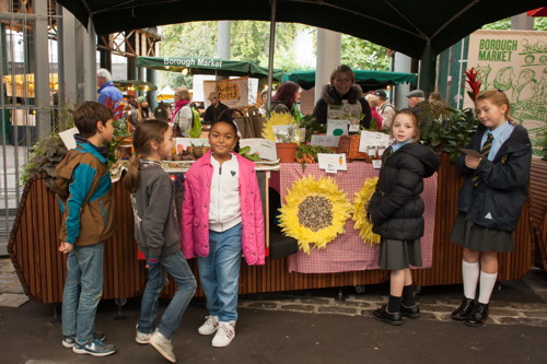 Young traders sell their harvest produce at Borough Market