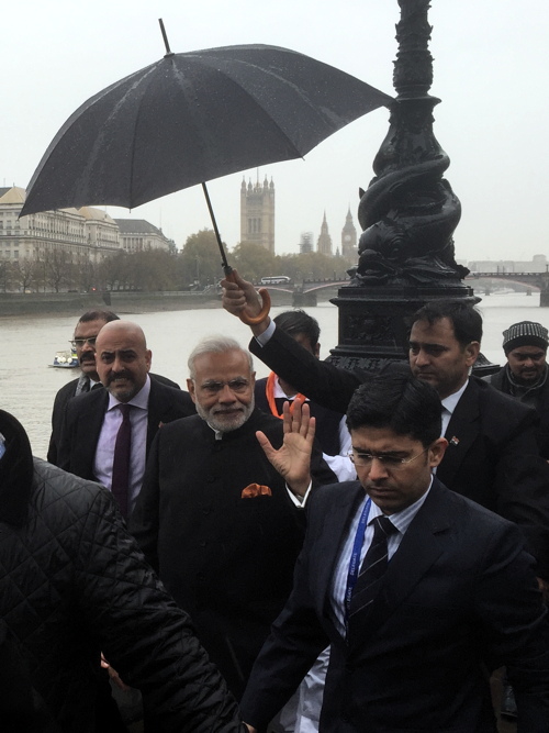 holding umbrella for modi